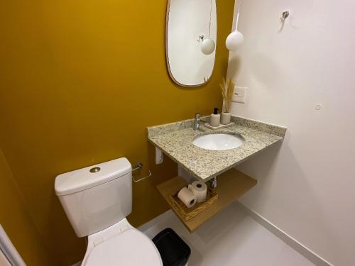 ein Badezimmer mit einem weißen WC und einem Waschbecken in der Unterkunft SP Code Paulista by Housi in São Paulo