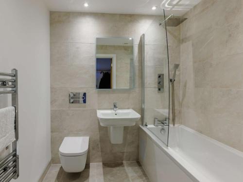 a bathroom with a sink and a toilet and a shower at 2 Bed in Bude 90096 in Bude