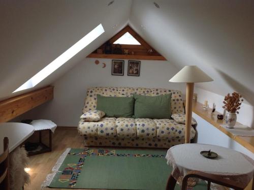 a living room with a couch in a attic at Apartment Tanja in Kranjska Gora