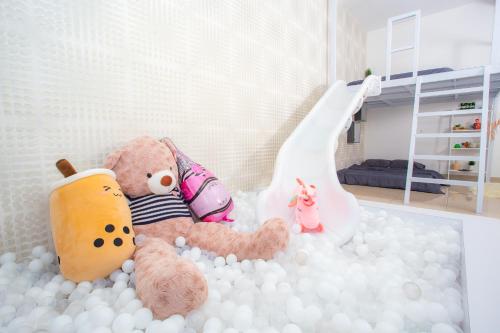 a stuffed teddy bear sitting in a pile of balls at Mount Austin Manhanttan Sovo by Cactus Homestay in Johor Bahru