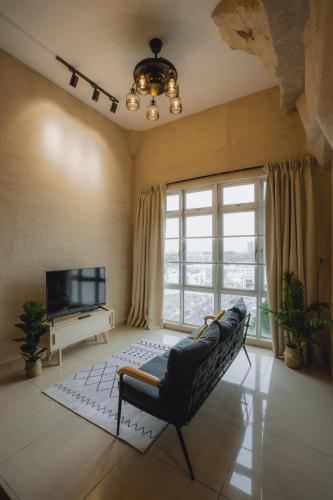 a living room with a couch and a television at Mount Austin Manhanttan Sovo by Cactus Homestay in Johor Bahru