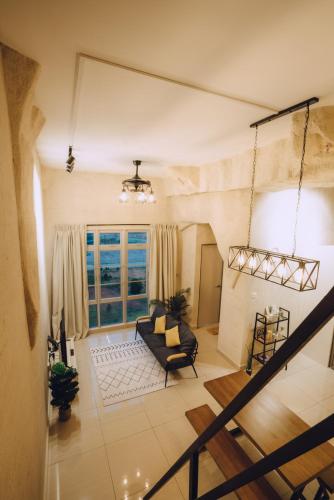 a living room with a couch and a window at Mount Austin Manhanttan Sovo by Cactus Homestay in Johor Bahru