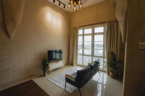 a living room with a couch and a television at Mount Austin Manhanttan Sovo by Cactus Homestay in Johor Bahru