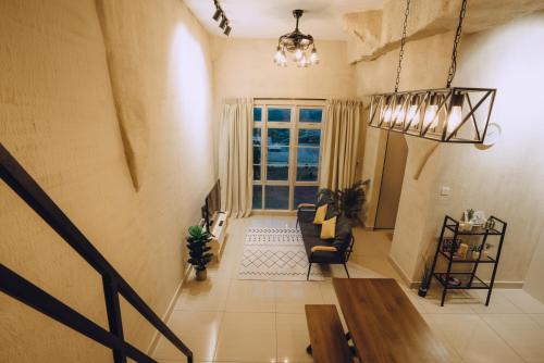 a living room with a couch and a window at Mount Austin Manhanttan Sovo by Cactus Homestay in Johor Bahru
