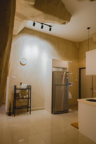 a kitchen with a stainless steel refrigerator in a room at Mount Austin Manhanttan Sovo by Cactus Homestay in Johor Bahru