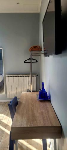 a dining room table with a blue vase on it at Al Binario Brescia in Brescia