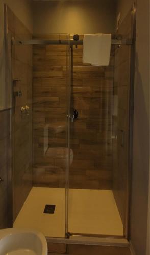 a shower with a glass door in a bathroom at Al Binario Brescia in Brescia