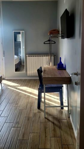 a room with a wooden table and a view of a bedroom at Al Binario Brescia in Brescia