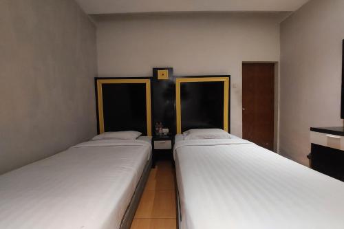 Ένα ή περισσότερα κρεβάτια σε δωμάτιο στο Hotel Bumi Malaya