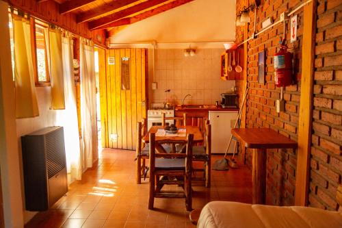 a kitchen with a table and chairs in a room at Costa del Río in Lago Puelo