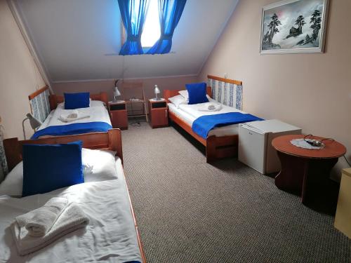 En eller flere senge i et værelse på Iglódi Panzió