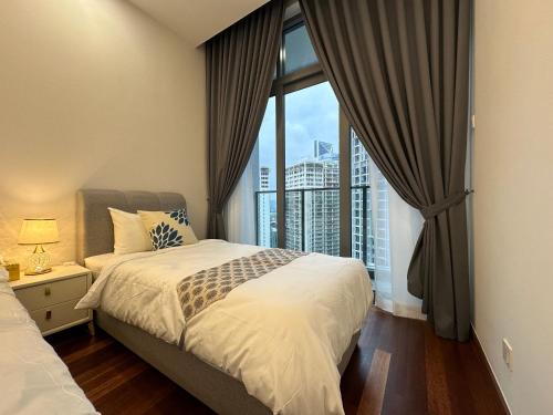 a bedroom with a bed and a large window at Royce Residences by Romeo Bnb in Kuala Lumpur