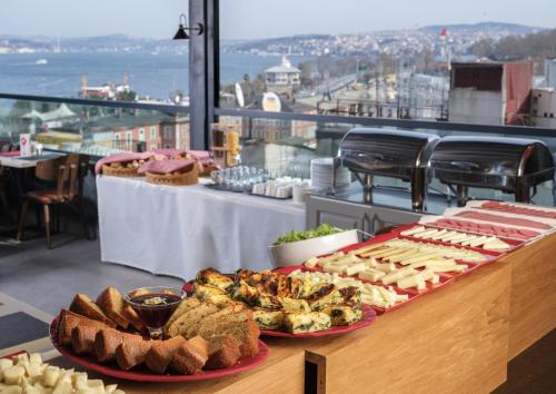 a table with bread and pastries on top of a building at Glamour Hotel Istanbul Sirkeci in Istanbul