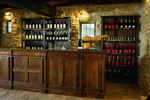 a bar with a bunch of bottles of wine at Castello di Viano in Viano