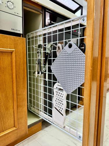 a kitchen door with a rack of kitchen utensils at Stayinn Itoshima - Vacation Rental in Itoshima
