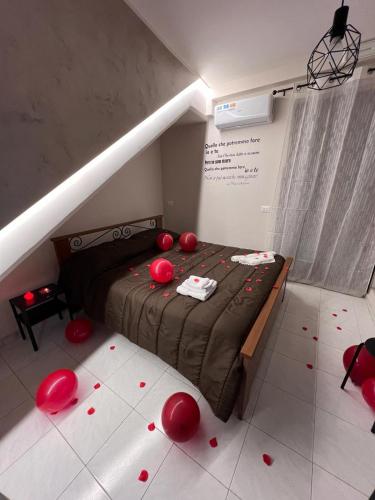 a bedroom with a bed with red balls on the floor at Spazio Relax B&B in Bellizzi Irpino