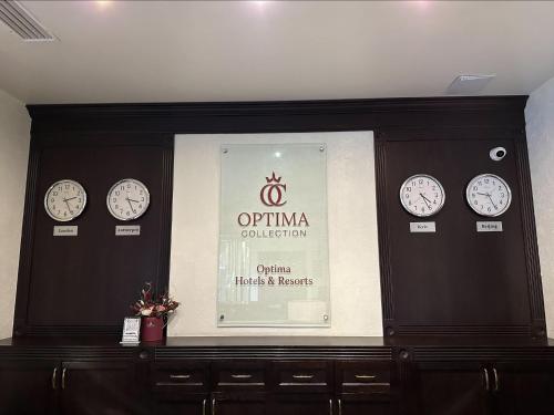 a display window with clocks on a wall at Optima Collection Troitska in Dnipro