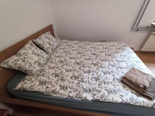 a bed with a black and white blanket and pillows at Rooms in the Centrum in Warsaw