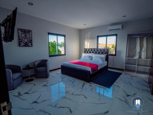 a living room with a bed and a couch at Luxury Sky Residence Penthouse in Paramaribo