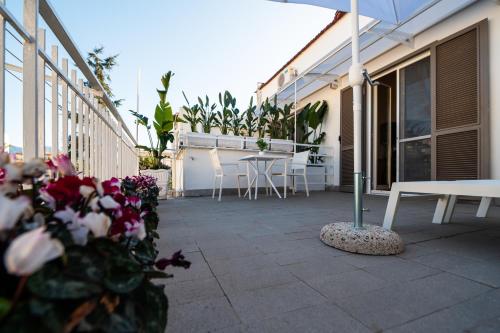 a patio with a table and chairs and an umbrella at Terra Mia in Piazza in Pompei