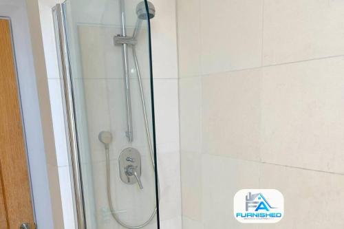 a shower in a bathroom with a glass door at Penthouse - Central - Parking in Harrogate