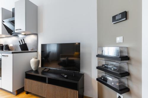 a living room with a tv on a table at Cosy brand-new studio in a calm discrict of Vienna in Vienna