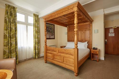 a bedroom with a canopy bed in a room at Lismoyne Hotel in Fleet