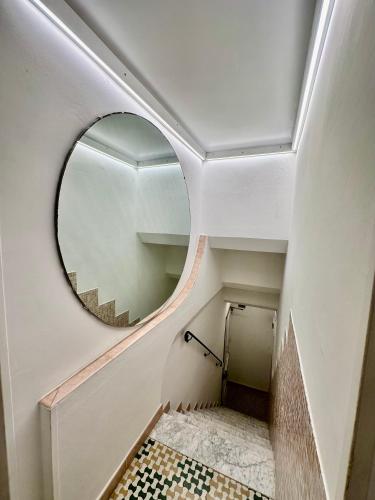 a hallway with a round mirror and a tile floor at The Vernazza Main Plaza - Rooms & Apartment in Vernazza