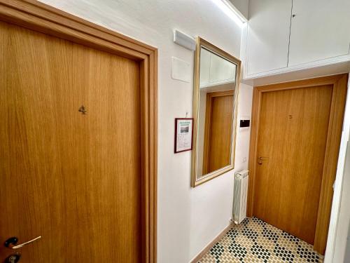 a hallway with a wooden door and a mirror at The Vernazza Main Plaza - Rooms & Apartment in Vernazza