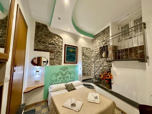 a bedroom with a bed with towels on it at The Vernazza Main Plaza - Rooms & Apartment in Vernazza