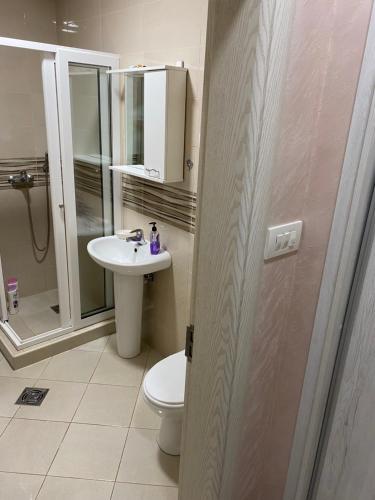 a bathroom with a toilet and a sink and a shower at Impressive Apartment in Nikšić