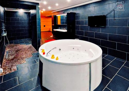 a bath tub in a bathroom with blue tiles at Luxuriöse Villa am Wiesensee in Pottum