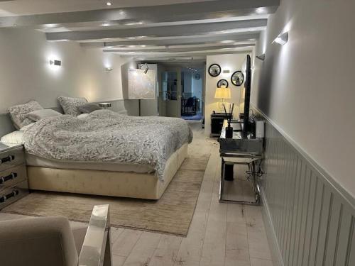 a bedroom with a large bed and a staircase at Unique Royal Basement residence in Amsterdam