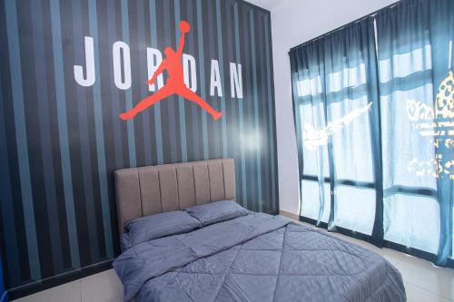 a bedroom with a bed with a sign on the wall at Mount Austin Manhanttan Sovo by Cactus Homestay in Johor Bahru
