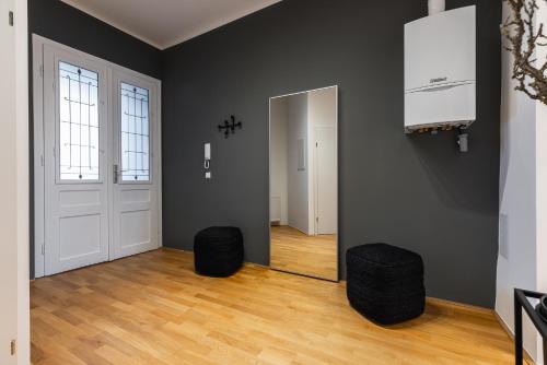 an empty room with a door and two stools at Cosy brand-new studio in a calm discrict of Vienna in Vienna