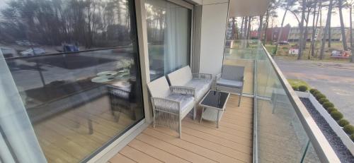 a balcony with a table and chairs on it at Apartament Sunset Solaris Darłówko in Darłówko
