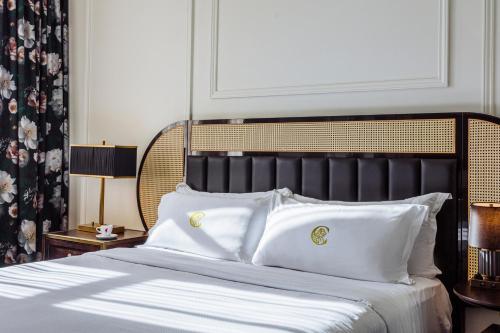 a bedroom with a large bed with white pillows at The Candler Hotel Atlanta, Curio Collection by Hilton in Atlanta