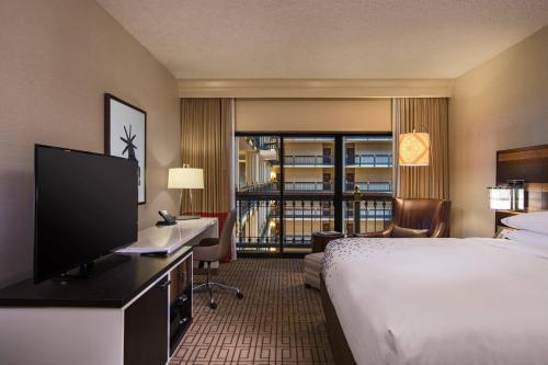 a hotel room with a bed and a flat screen tv at Renaissance Austin Hotel in Austin