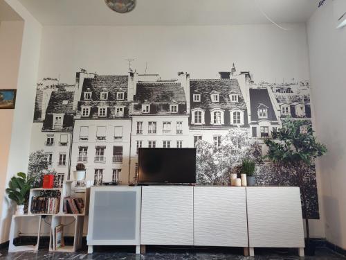 a living room with a wall mural of buildings at Casa Stella in Viareggio