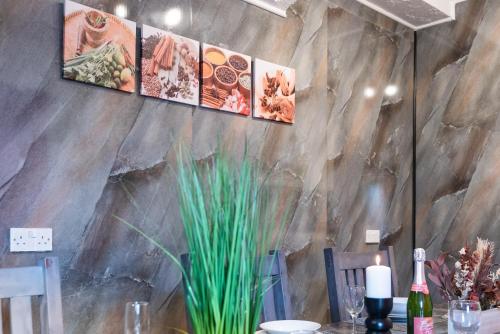a dining room with a table with a stone wall at 6 Roomy Bedrooms Favour Spacious Inn - Sleeps 13 Hull Central Location in Hull