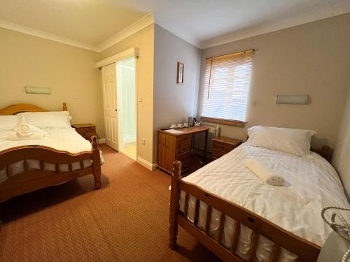 a bedroom with two beds and a window at The Exchange Hotel in Brigg