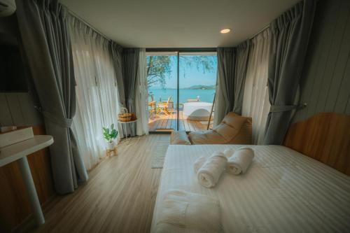 - une chambre avec un lit et une vue sur l'océan dans l'établissement Sea Sand See Sky Beach Front Resort, à Phuket