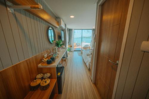 a room with a hallway with a row of shoes at Sea Sand See Sky Beach Front Resort in Phuket