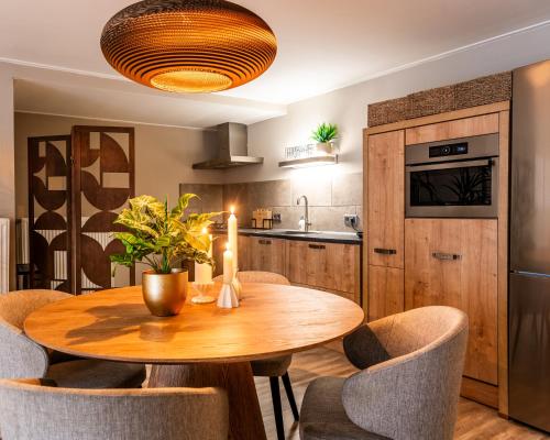 eine Küche und ein Esszimmer mit einem Holztisch und Stühlen in der Unterkunft Stadsappartement Franeker 9 in Franeker