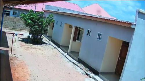 a view of a white building with a pink roof at Home Boy Lodge in Dodoma