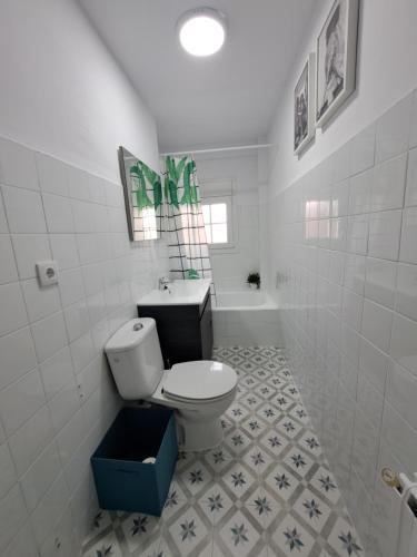a white bathroom with a toilet and a sink at CASA SÁDABA in Avila