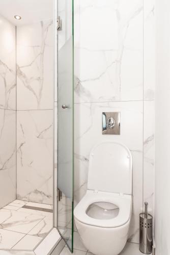 a bathroom with a toilet and a glass shower at Sea & the City in Thessaloniki