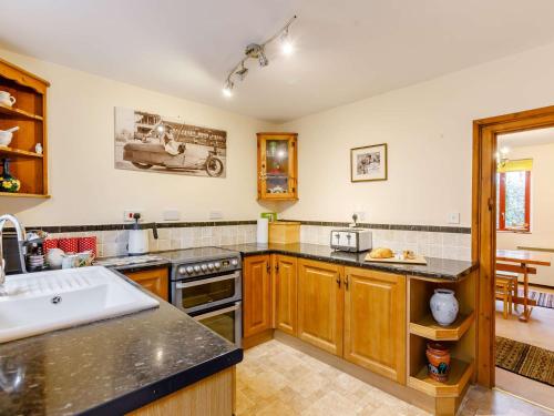 a kitchen with a sink and a stove top oven at 3 Bed in Shipston-on-Stour 90481 in Honington