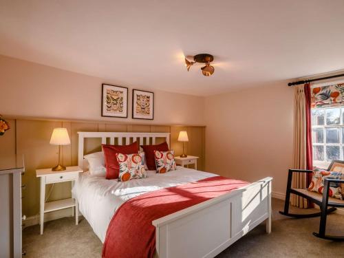 a bedroom with a large white bed with red pillows at 2 Bed in Foulsham 90675 in Foulsham