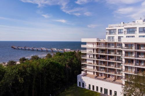 a hotel overlooking the ocean and a pier at Aquamarina Prima 049 by Renters in Międzyzdroje